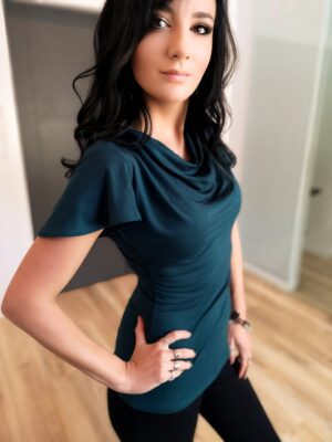 Green cowl neck top with draping sleeve.