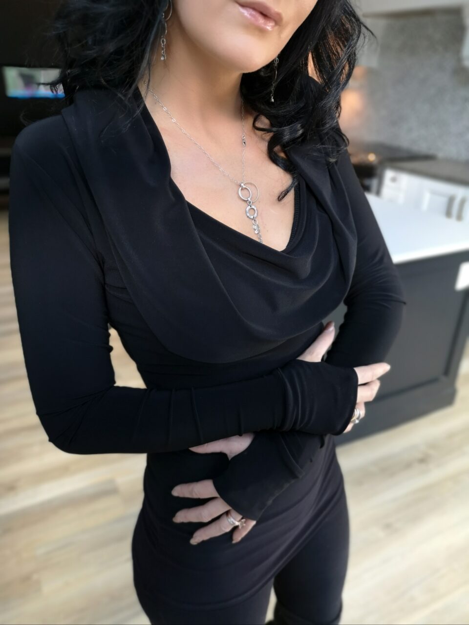 Black long-sleeve hooded cowl neck top.