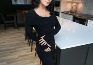Black long-sleeve hooded cowl neck top.