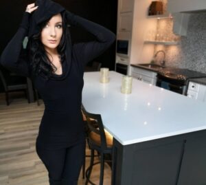 Black long-sleeve hooded cowl neck top.
