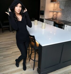 Black long-sleeve hooded cowl neck top.