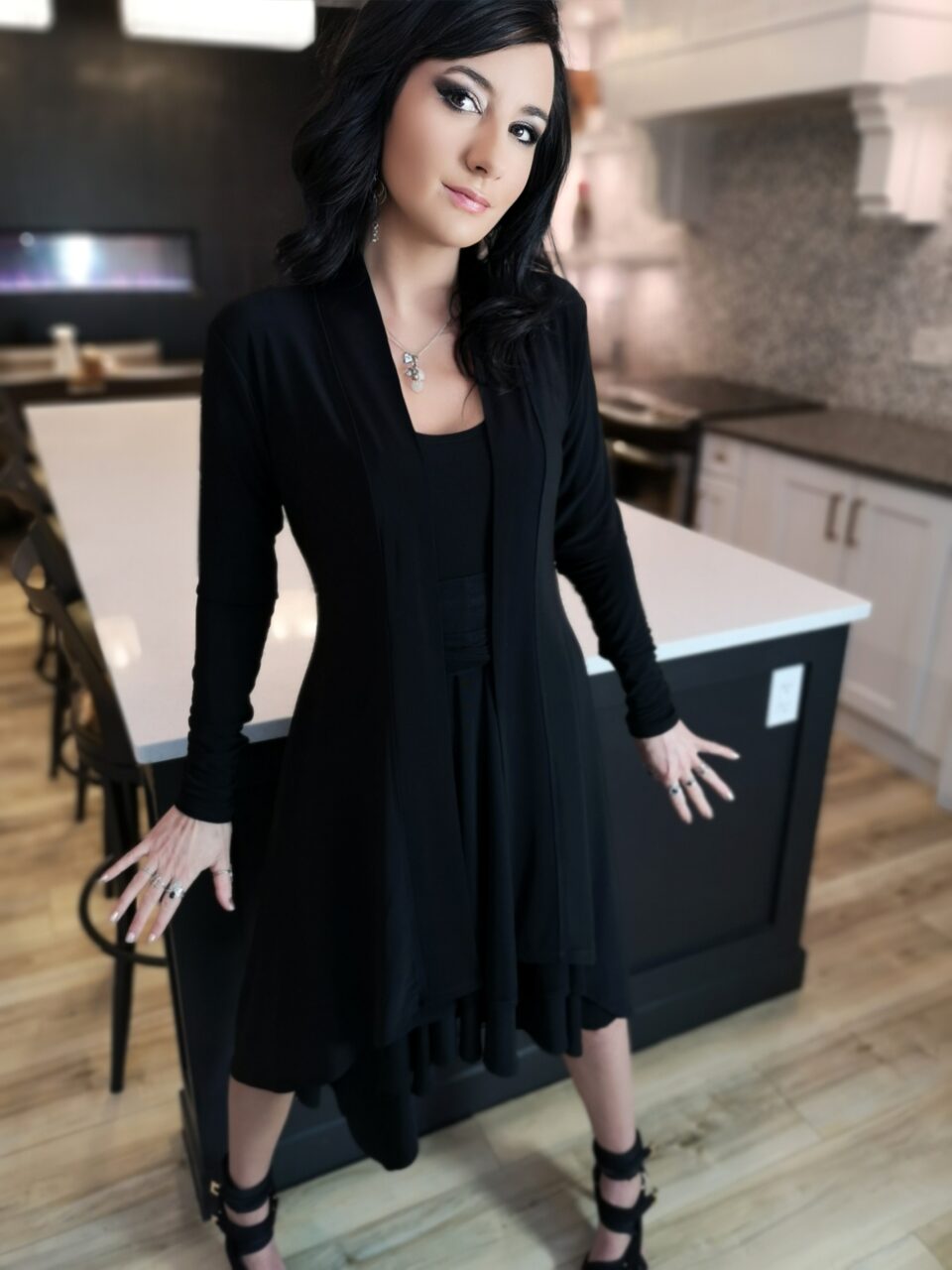 Long black cardigan, poly spandex blend.