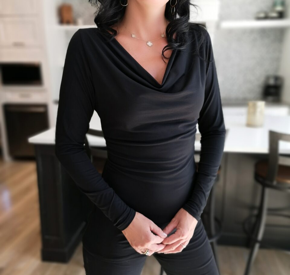 Black long-sleeve fitted cowl neck top.