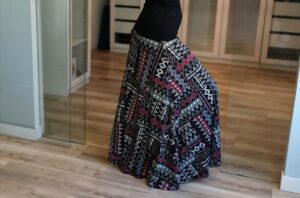 Red and white on black geometrical print floor length printed skirt.