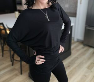 Black off-the-shoulder unsymmetrical draping tunic top.