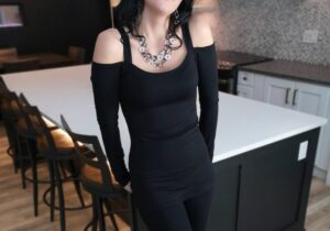 Exposed shoulder long sleeve black tunic top.