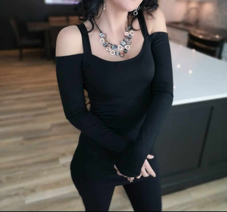 Exposed shoulder long sleeve black tunic top.