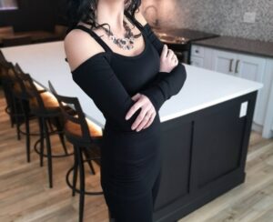 Exposed shoulder long sleeve black tunic top.