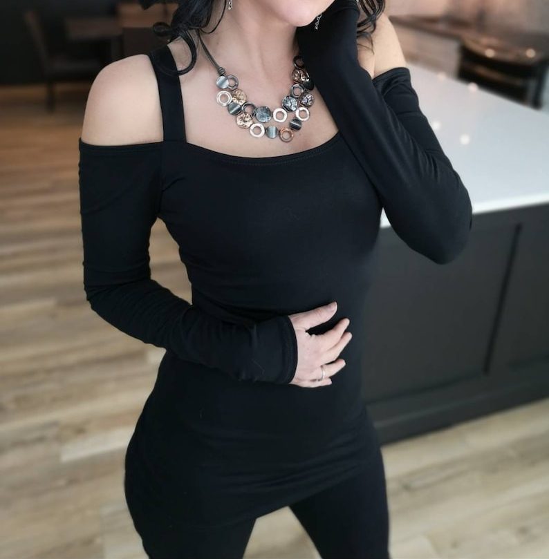 Exposed shoulder long sleeve black tunic top.