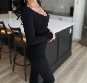 Soft fitted low-cut long sleeve black top.