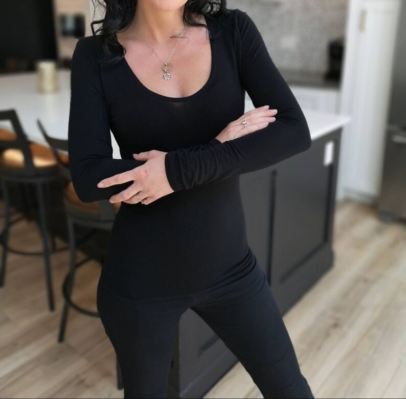 Soft fitted low-cut long sleeve black top.