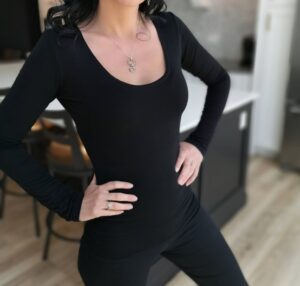 Soft fitted low-cut long sleeve black top.