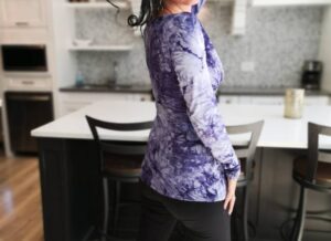 Purple tie-dye cowl neck long-sleeve top.