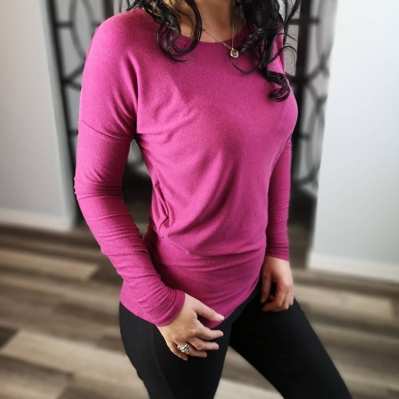 Vibrant pink long-sleeve draping top.