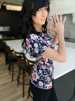 Pink on navy blue fitted floral print cowl neck top.