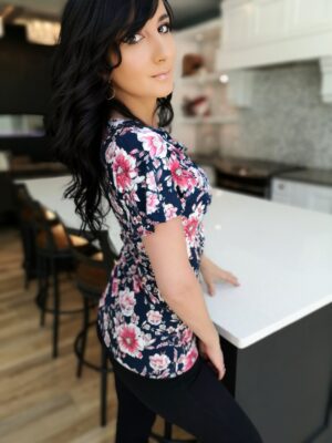 Pink on navy blue fitted floral print cowl neck top.