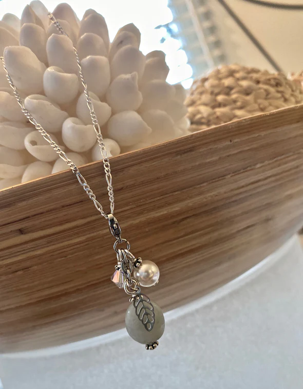 Silver, pearl and iridescent clear crystal sims stainless steel leaf charm.