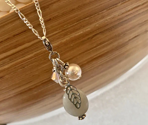 Silver, pearl and iridescent clear crystal sims stainless steel leaf charm.