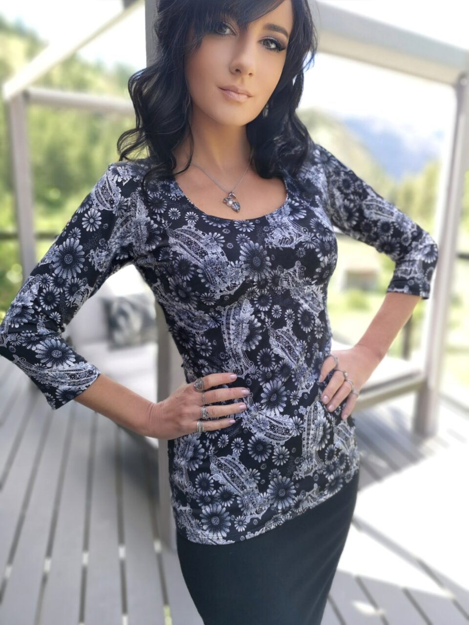 Black round neck fitted top with sunflower print.