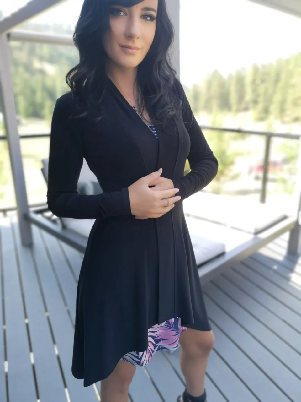 Long-sleeve black cardigan with pointed sides.