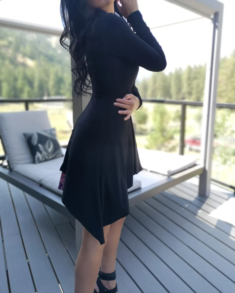 Long-sleeve black cardigan with pointed sides.