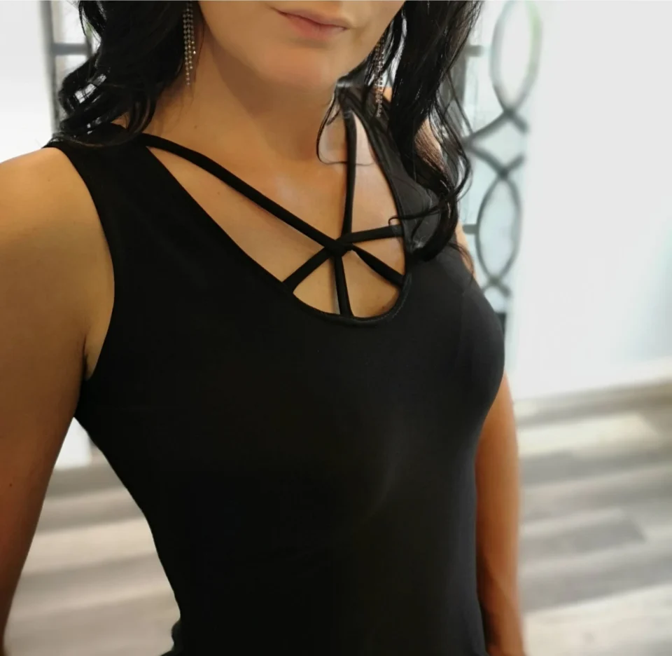 Black sleeveless top with lace trimming around the bottom and string detail.