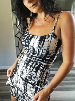 Cute little summer dress in neutral black and white abstract stripey print.