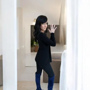 Black long sleeve top with a draping feature in the bust.