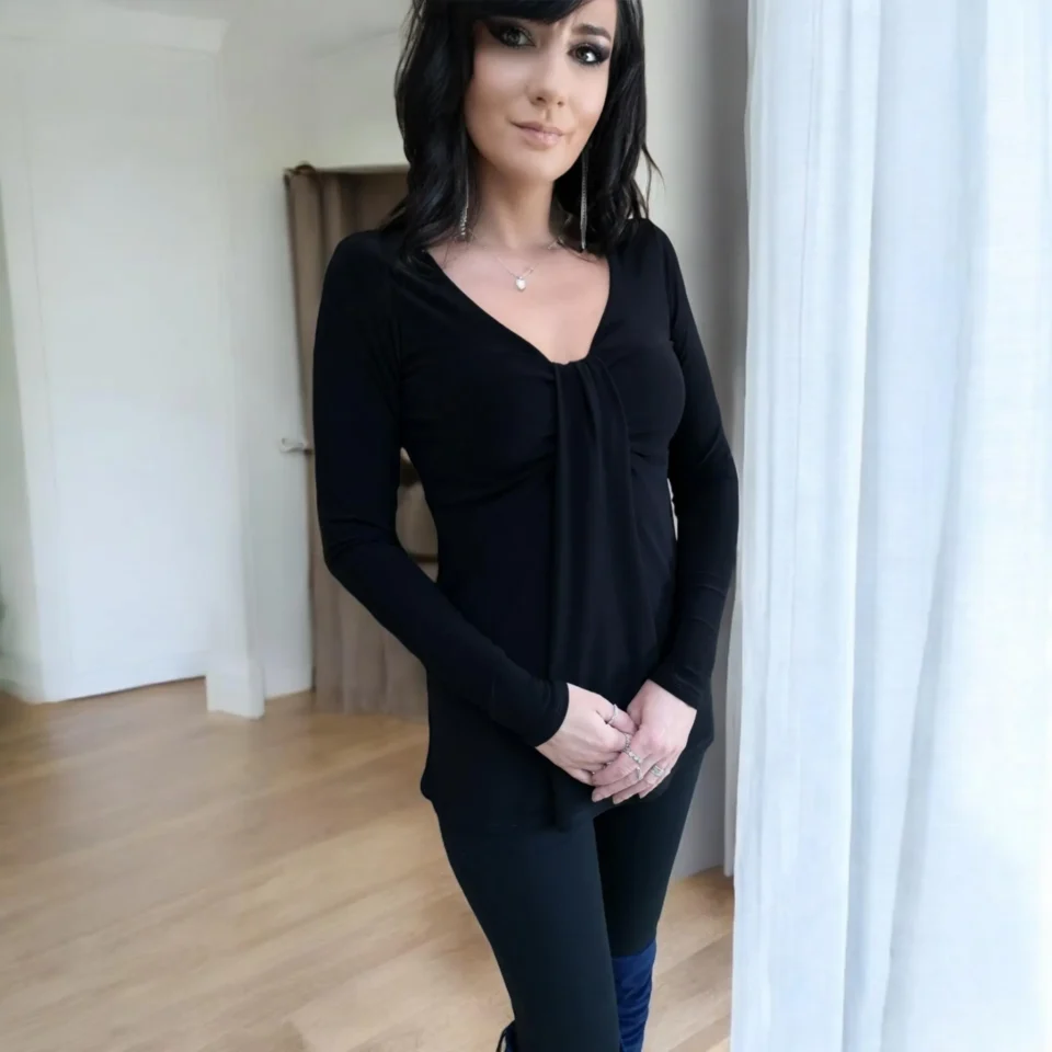 Black long sleeve top with a draping feature in the bust.