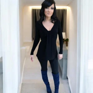 Black long sleeve top with a draping feature in the bust.