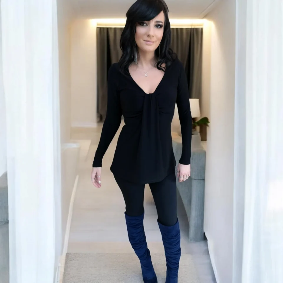 Black long sleeve top with a draping feature in the bust.
