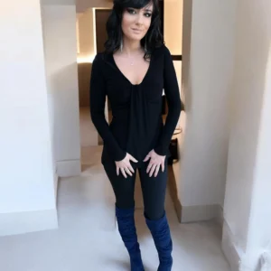 Black long sleeve top with a draping feature in the bust.