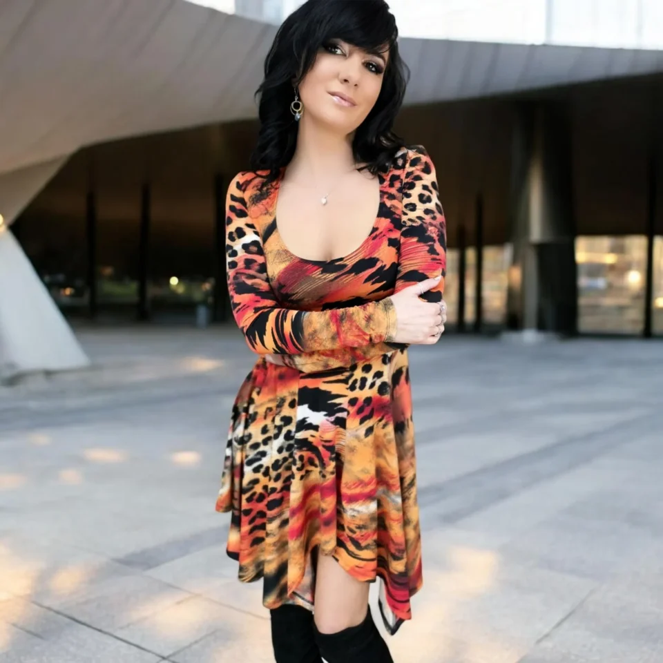 Long-sleeve orange, black and yellow animal print tissue hem round neck mini dress.