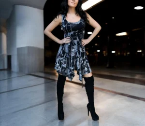 Gray on black newspaper print sleeveless non-symmetrical short dress.