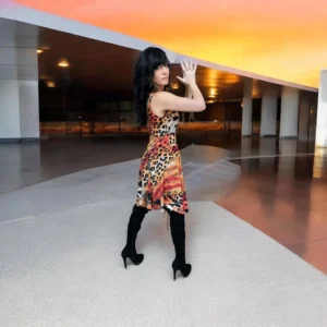 Sleeveless orange, black and yellow animal print tissue hem round neck mini dress.
