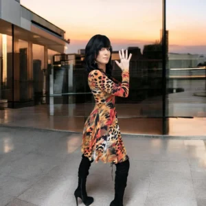 Long-sleeve orange, black and yellow animal print tissue hem round neck mini dress.