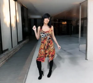 Sleeveless orange, black and yellow animal print tissue hem round neck mini dress.