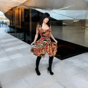 Cap sleeve orange, black and yellow animal print tissue hem round neck mini dress.