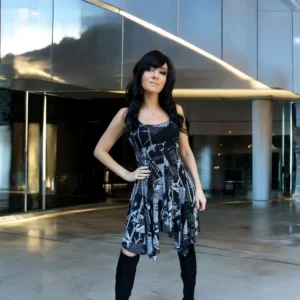 Gray on black newspaper print sleeveless non-symmetrical short dress.