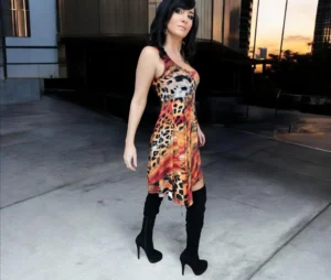 Sleeveless orange, black and yellow animal print tissue hem round neck mini dress.