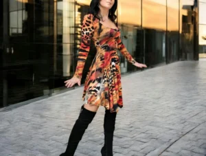 Long-sleeve orange, black and yellow animal print tissue hem round neck mini dress.