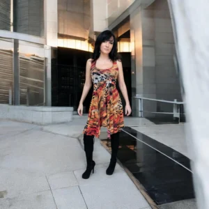 Sleeveless orange, black and yellow animal print tissue hem round neck mini dress.