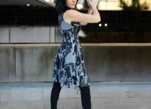 Gray on black newspaper print sleeveless non-symmetrical short dress.