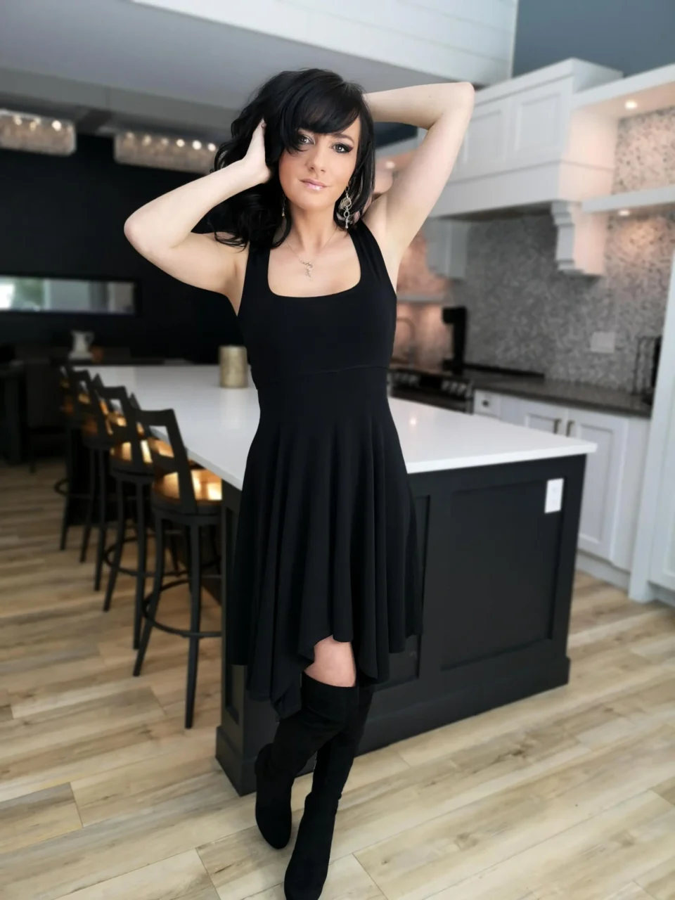 Black sleeveless tissue hem short dress.