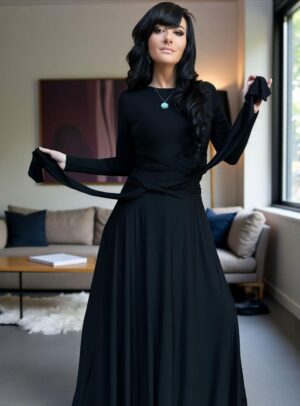 Versatile reversible black long-sleeve fitted maxi dress in bamboo/spandex, with V-neck on one side, boat neckline on the other, and two long panels that can be cinched and tied in various ways.