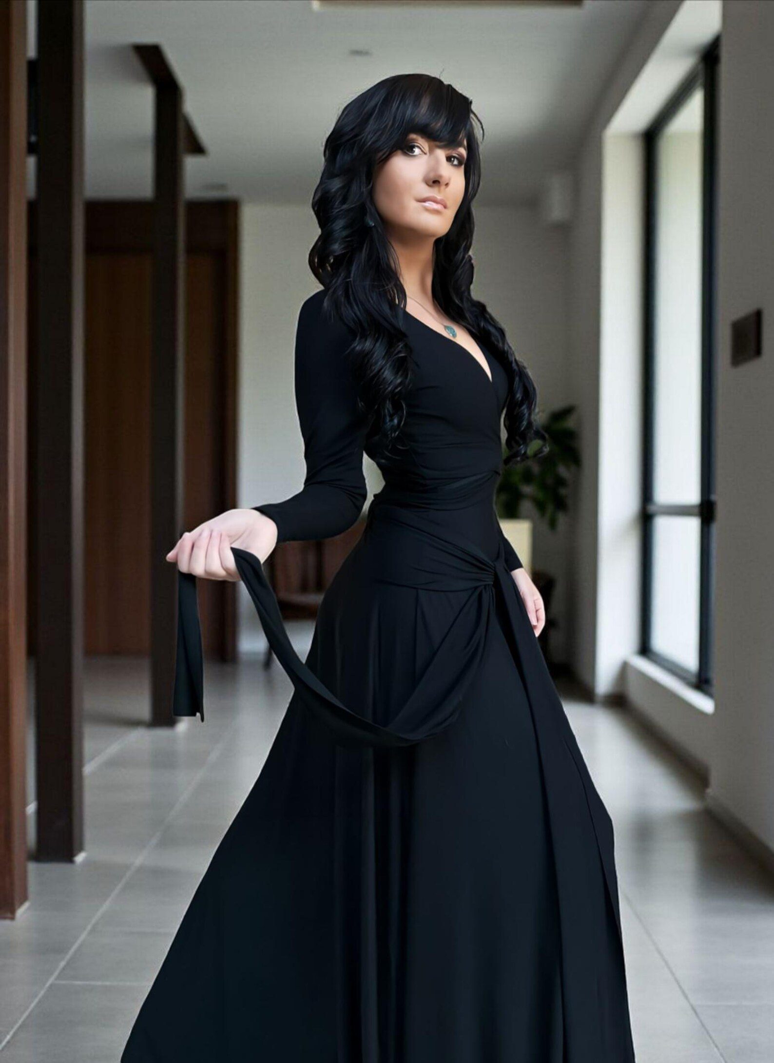 Versatile reversible black long-sleeve fitted maxi dress in bamboo/spandex, with V-neck on one side, boat neckline on the other, and two long panels that can be cinched and tied in various ways.