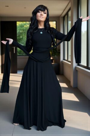 Versatile reversible black long-sleeve fitted maxi dress in bamboo/spandex, with V-neck on one side, boat neckline on the other, and two long panels that can be cinched and tied in various ways.