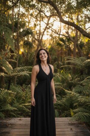 Versatile black sleeveless flowy maxi dress soft sustainable bamboo/spandex fabric with empire waist and pull-up detail.