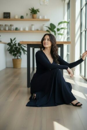 Maxi navy blue long-sleeve infinity fitted wrap dress, reversible with v-neck or boat neck options, and provided with long waist ties.