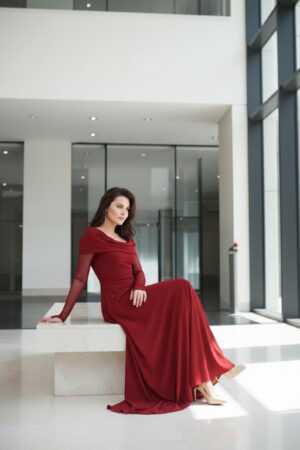 Scarlet red hooded cowl neck maxi dress with mesh sleeves and finger cutouts.